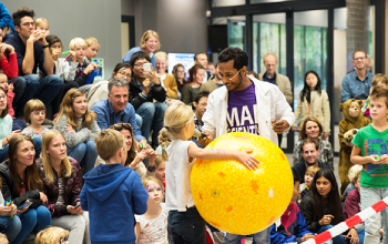 A mad scientist putting on a science show for kids.